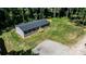 Aerial view of home with a spacious lawn, a gravel driveway, and surrounded by lush green trees, creating a private oasis at 110 Lambert Ln, Statesville, NC 28677