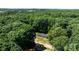Secluded home surrounded by dense, mature trees, offering privacy and tranquility; view showcases a well-maintained lawn at 110 Lambert Ln, Statesville, NC 28677