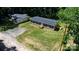 Aerial view of a home featuring a wooden deck, driveway, and manicured lawn at 110 Lambert Ln, Statesville, NC 28677