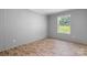 Bright bedroom featuring wood-look floors and natural light from the window at 110 Lambert Ln, Statesville, NC 28677