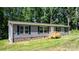Charming ranch-style home with gray siding, dark shutters, and a welcoming front porch amid a wooded setting at 110 Lambert Ln, Statesville, NC 28677