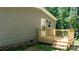 Charming porch with natural wood tones, set against a neutral siding and lush greenery, creating an inviting outdoor space at 110 Lambert Ln, Statesville, NC 28677