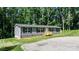 Lovely single-story home with gray siding, dark shutters, and a wood porch, nestled in a lush, green landscape at 110 Lambert Ln, Statesville, NC 28677