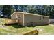 Home exterior with a deck, siding, brick foundation and manicured lawn at 110 Lambert Ln, Statesville, NC 28677