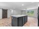 The kitchen features a central island with dark cabinets, light countertops, and a view of the backyard at 110 Lambert Ln, Statesville, NC 28677