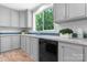 Charming kitchen with gray cabinets, black appliances, sleek countertops, and a bright window offering natural light at 110 Lambert Ln, Statesville, NC 28677