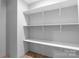 Walk-in closet with built-in white shelves, offering ample storage space and a clean, organized look at 110 Lambert Ln, Statesville, NC 28677