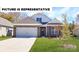 Charming single-story home with brick accents, a two-car garage, and a well-manicured lawn at 119 S Shayna Rd, Troutman, NC 28166