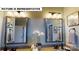 Bathroom featuring double sinks, framed mirrors, cabinet lighting, and decorative hand towels at 124 S Shayna Rd, Troutman, NC 28166