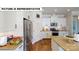 Modern kitchen features white cabinets, stainless steel appliances, and an open layout at 124 S Shayna Rd, Troutman, NC 28166