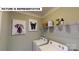 Laundry room featuring a washer, dryer, wire rack shelving, and charming dog artwork at 124 S Shayna Rd, Troutman, NC 28166