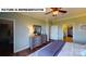 Green-painted main bedroom boasts a ceiling fan, dresser, closet, and a peek into the ensuite bathroom at 124 S Shayna Rd, Troutman, NC 28166