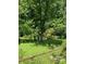 Lush backyard featuring beautiful trees and a chain-link fence at 1313 Lower Dallas Hwy Hwy, Dallas, NC 28034
