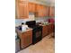Kitchen features wooden cabinets, tile flooring, and black appliances at 1313 Lower Dallas Hwy Hwy, Dallas, NC 28034