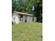 Old, weathered outbuilding featuring three doors on a grassy lot at 1313 Lower Dallas Hwy Hwy, Dallas, NC 28034