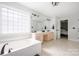 Spacious bathroom featuring a soaking tub, double vanity, and tile flooring at 139 Forest Walk Way, Mooresville, NC 28115