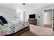 Spacious bedroom with neutral walls and carpet, dresser, and large TV at 139 Forest Walk Way, Mooresville, NC 28115