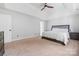 Bright bedroom with tray ceiling, neutral walls and carpet, with ensuite bathroom at 139 Forest Walk Way, Mooresville, NC 28115