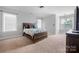 Bright bedroom features neutral walls and carpet, along with two large windows at 139 Forest Walk Way, Mooresville, NC 28115