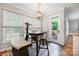 Bright breakfast nook featuring a modern chandelier, dark wood table, and access to the outdoor deck at 139 Forest Walk Way, Mooresville, NC 28115