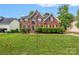 Charming brick two-story home featuring lush green lawn and manicured shrubbery enhancing curb appeal at 139 Forest Walk Way, Mooresville, NC 28115