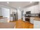Well-lit kitchen with hardwood floors, stainless steel appliances, and ample cabinet space for storage at 139 Forest Walk Way, Mooresville, NC 28115
