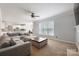 Spacious living room with large windows, fireplace, and a comfortable sectional sofa, connected to the kitchen at 139 Forest Walk Way, Mooresville, NC 28115