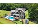 Expansive aerial view of the estate featuring a custom home, swimming pool, outdoor kitchen and lush landscaping at 14701 Cabarrus Rd, Mint Hill, NC 28227