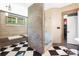 Well appointed bathroom featuring a large tub, glass shower, and elegant checkerboard flooring at 14701 Cabarrus Rd, Mint Hill, NC 28227