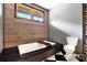 Comfortable bathroom with a soaking tub and dark granite details at 14701 Cabarrus Rd, Mint Hill, NC 28227
