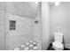Bright bathroom featuring a tile shower with custom black and white mosaic tile accents at 14701 Cabarrus Rd, Mint Hill, NC 28227