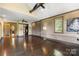 Large bonus room offers hardwood floors, exposed brick, and ample natural light at 14701 Cabarrus Rd, Mint Hill, NC 28227