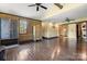 Spacious bonus room with hardwood floors, a vintage cabinet, and modern ceiling fans at 14701 Cabarrus Rd, Mint Hill, NC 28227