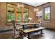 Chic dining room boasts modern lighting fixtures and views of the outdoor greenery at 14701 Cabarrus Rd, Mint Hill, NC 28227