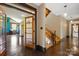 Spacious entryway showcases hardwood floors, modern staircase, and a glimpse into the kitchen at 14701 Cabarrus Rd, Mint Hill, NC 28227