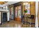 Cozy entryway featuring wine fridge, bar seating and glass doors to a patio space with lovely natural light at 14701 Cabarrus Rd, Mint Hill, NC 28227