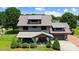 Aerial view of a two-story home with a manicured lawn and charming covered front porch at 14701 Cabarrus Rd, Mint Hill, NC 28227