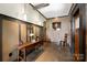 Elegant foyer with a console table, stylish lighting, and exposed brick walls at 14701 Cabarrus Rd, Mint Hill, NC 28227