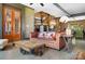 Cozy living area features eclectic decor, views of the outdoor greenery, and natural light at 14701 Cabarrus Rd, Mint Hill, NC 28227