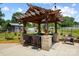 Well-appointed outdoor kitchen with bar seating and a grill perfect for entertaining friends and Gathering at 14701 Cabarrus Rd, Mint Hill, NC 28227