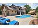Stunning pool area with an outdoor kitchen, lounge chairs and mature landscaping, offering a resort-like feel at 14701 Cabarrus Rd, Mint Hill, NC 28227