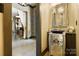 Stylish powder room boasts a unique sink, mirrored vanity, and adjacent living area at 14701 Cabarrus Rd, Mint Hill, NC 28227