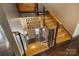 Modern staircase features wood treads, black metal railings, and eye-catching artwork at 14701 Cabarrus Rd, Mint Hill, NC 28227