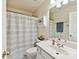 This compact bathroom features a sink, toilet, shower with curtain, and a mirrored vanity at 1564 Trippett Nw St, Concord, NC 28027
