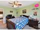This cozy bedroom has light green walls, a ceiling fan, and a unique pineapple pattern on the bedspread at 1564 Trippett Nw St, Concord, NC 28027