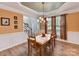 Elegant dining room with tray ceiling, chandelier, and hardwood floors at 1564 Trippett Nw St, Concord, NC 28027