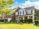 Beautiful two-story home with brick and vinyl siding and manicured lawn at 1564 Trippett Nw St, Concord, NC 28027