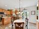 Bright kitchen and dining area with wood cabinets, stainless steel appliances, and a door to the backyard at 1564 Trippett Nw St, Concord, NC 28027