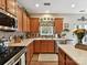 Well-equipped kitchen featuring wood cabinets, granite countertops, stainless steel appliances, and a center island at 1564 Trippett Nw St, Concord, NC 28027