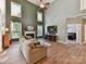 Spacious living room featuring high ceilings, a fireplace, large windows and an adjacent bedroom with a queen-sized bed at 1564 Trippett Nw St, Concord, NC 28027